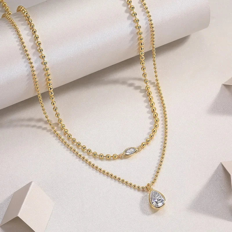 Moissanite pear pendant necklace
925 sterling silver layered necklace
VVS1 clarity moissanite jewelry
Symi Jewel gold bead chain
18K white gold plated necklace
Minimal luxury necklace for women
Waterproof hypoallergenic Moissanite chain
Elegant Moissanite layering necklace