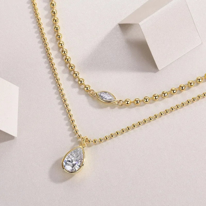 Moissanite pear pendant necklace
925 sterling silver layered necklace
VVS1 clarity Moissanite jewelry
Symi Jewel gold bead chain
18K white gold plated necklace
Minimal luxury necklace for women
Waterproof hypoallergenic Moissanite chain
Elegant Moissanite layering necklace