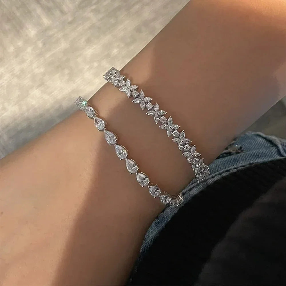 Close-up of 3x5mm pear cut moissanite stones in silver setting
pear cut moissanite tennis bracelet
GRA certified moissanite bracelet
white gold moissanite bracelet for women
luxury moissanite jewelry USA
D color 925 silver bracelet
dainty moissanite tennis bracelet
pear shaped diamond alternative bracelet
Symi Jewel tennis bracelet