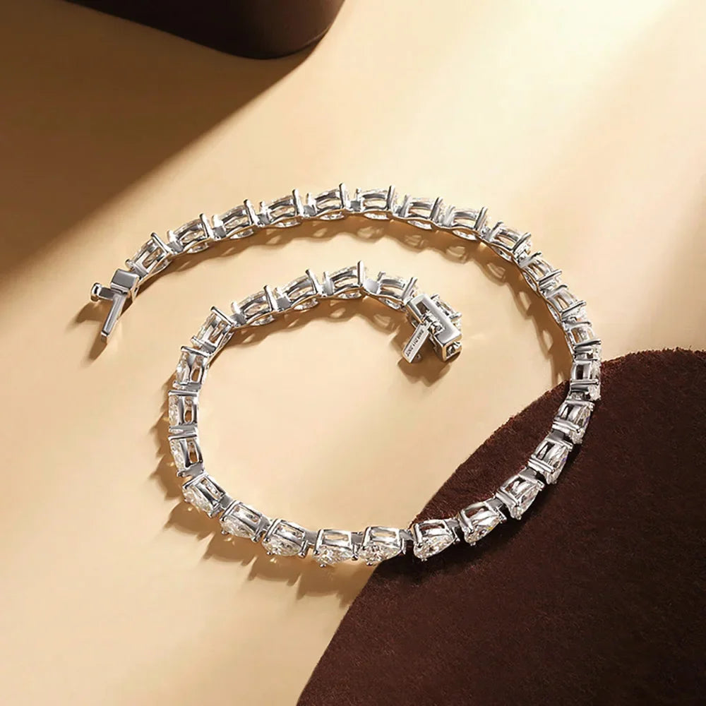 Close-up of 3x5mm pear cut moissanite stones in silver setting
pear cut moissanite tennis bracelet
GRA certified moissanite bracelet
white gold moissanite bracelet for women
luxury moissanite jewelry USA
D color 925 silver bracelet
dainty moissanite tennis bracelet
pear shaped diamond alternative bracelet
Symi Jewel tennis bracelet