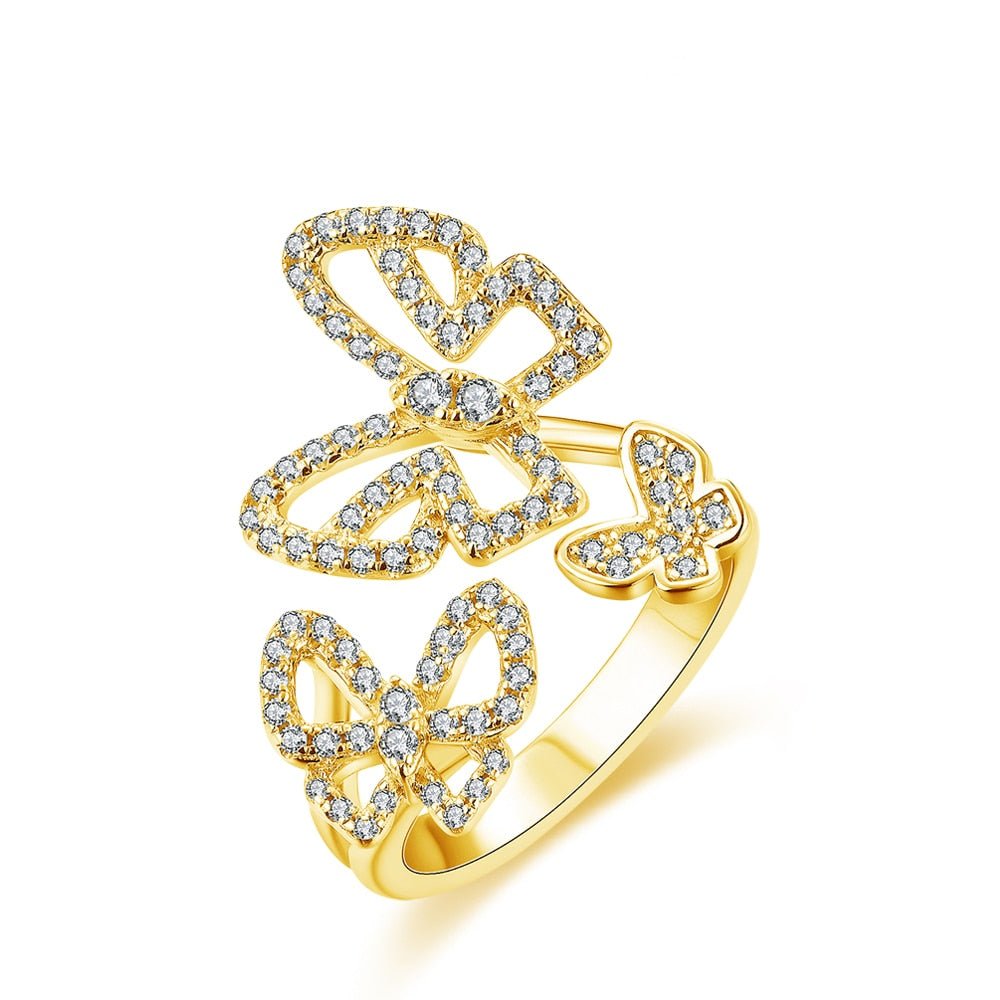 Sterling Silver Butterfly Ring
Sterling Silver Butterfly Ring
Moissanite butterfly ring in solid 925 sterling silver featuring three sparkling butterflies, displayed on a white background.
Close-up of triple butterfly moissanite ring on finger, sparkling brilliantly in natural light.
925 sterling silver butterfly ring worn by model in sheer long-sleeve top, showcasing elegant and whimsical style.
Product shot of butterfly ring with brilliant-cut moissanite stones and adjustable band design.