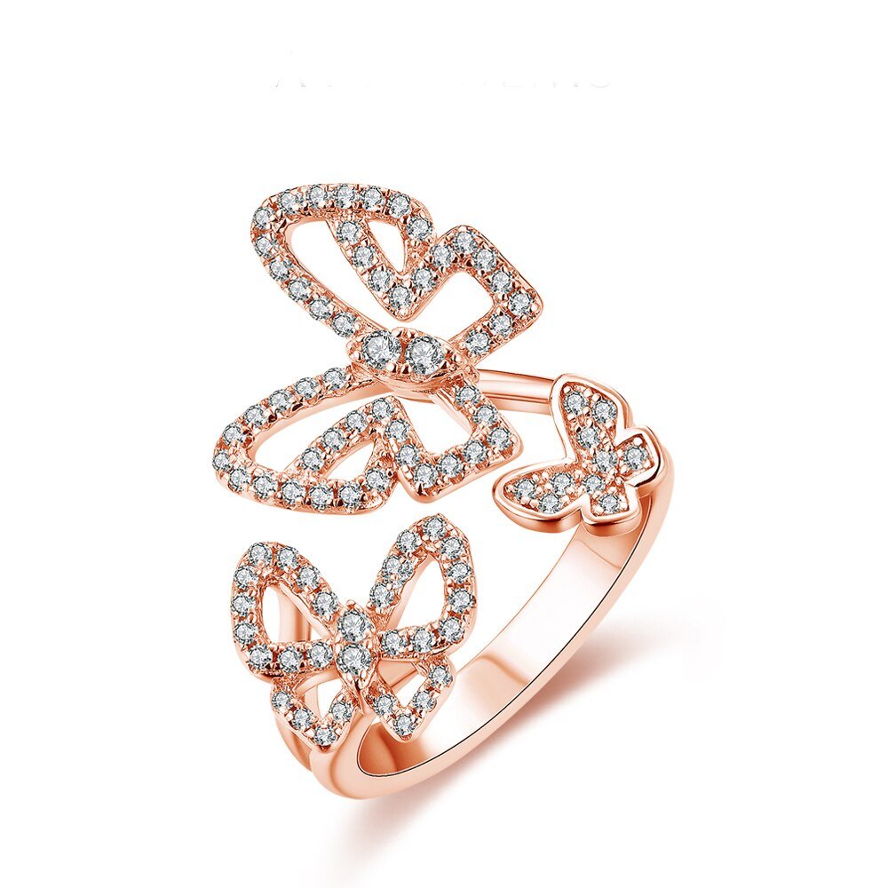 Sterling Silver Butterfly Ring
Sterling Silver Butterfly Ring
Moissanite butterfly ring in solid 925 sterling silver featuring three sparkling butterflies, displayed on a white background.
Close-up of triple butterfly moissanite ring on finger, sparkling brilliantly in natural light.
925 sterling silver butterfly ring worn by model in sheer long-sleeve top, showcasing elegant and whimsical style.
Product shot of butterfly ring with brilliant-cut moissanite stones and adjustable band design.