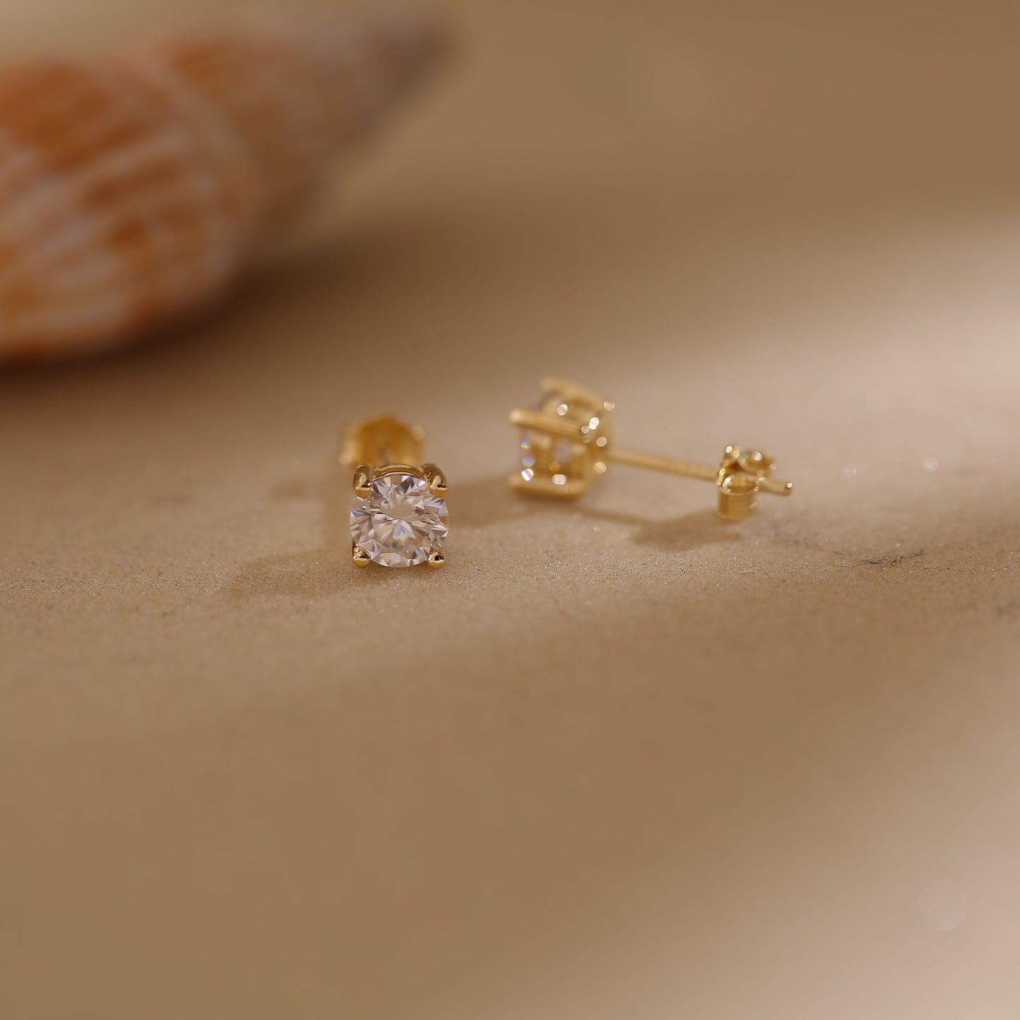A pair of round-cut moissanite stud earrings set in 18K gold plating, displayed inside an open Symi Jewel branded white jewelry box against a soft fabric background

moissanite stud earrings

18K gold plated earrings

round cut moissanite studs

dainty moissanite earrings

gold moissanite earrings for women

luxury moissanite jewelry

hypoallergenic gold earrings

minimalist moissanite studs

eco-friendly diamond alternative

Symi Jewel earrings

