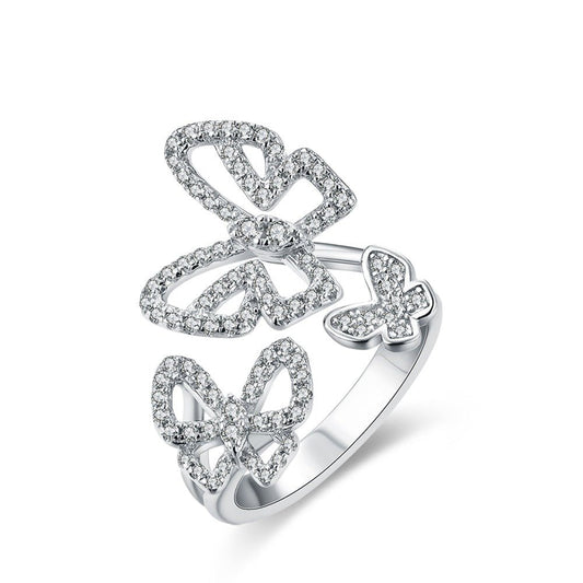 Sterling Silver Butterfly Ring

Moissanite butterfly ring in solid 925 sterling silver featuring three sparkling butterflies, displayed on a white background.

Close-up of triple butterfly moissanite ring on finger, sparkling brilliantly in natural light.

925 sterling silver butterfly ring worn by model in sheer long-sleeve top, showcasing elegant and whimsical style.

Product shot of butterfly ring with brilliant-cut Moissanite stones and adjustable band design.